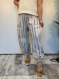 Charcoal striped linen blend balloon pants with lace patchwork details, elastic drawstring waist, and cuffed ankle hem by Mittoshop.