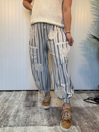 Charcoal striped linen blend balloon pants with lace patchwork details, elastic drawstring waist, and cuffed ankle hem by Mittoshop.