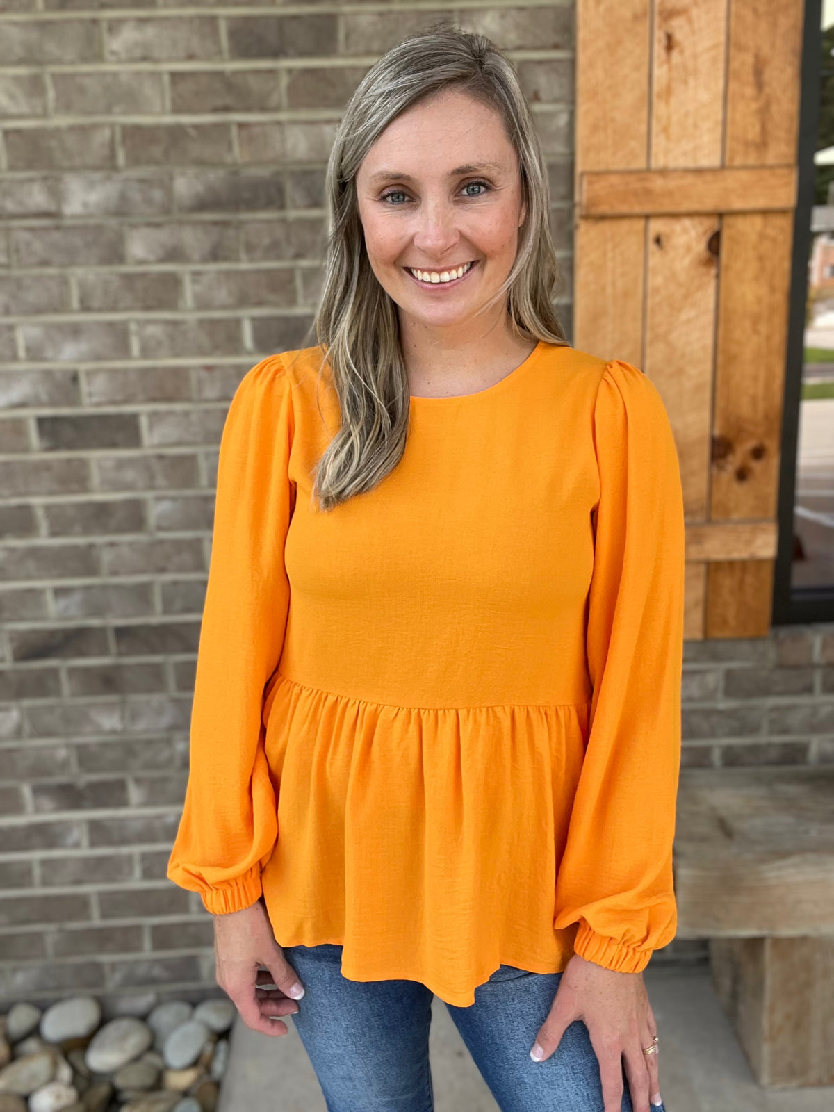 2282- Orange Solid Ruffle Hem Babydoll Style Long Sleeve Blouse