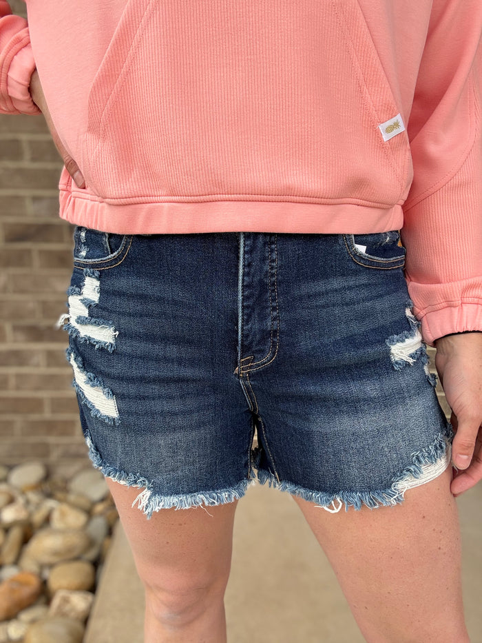 Dark Wash Tummy Control Mid Rise Frey Hem Shorts by Risen Jeans