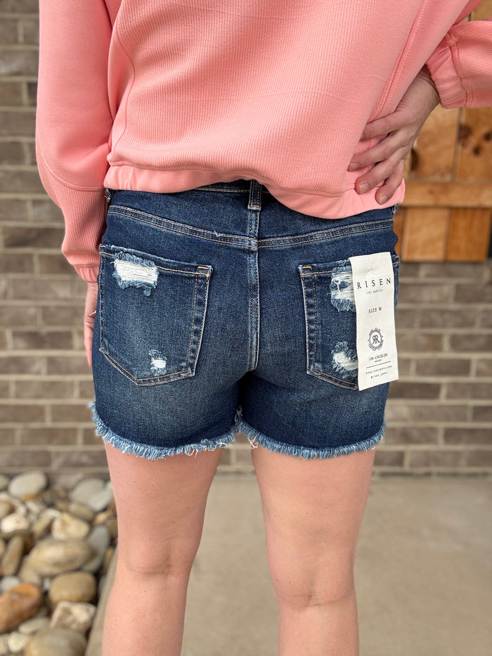 Dark Wash Tummy Control Mid Rise Frey Hem Shorts by Risen Jeans