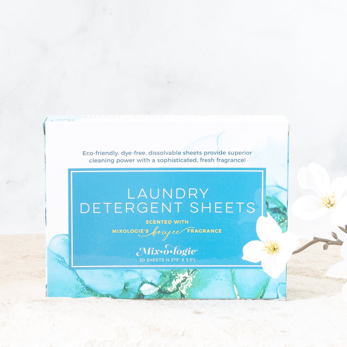 Laundry Detergent Sheets in a blue box scented with Mixologie's Boujee Fragrance. Eco-friendly, dry-free, dissolvable sheets provide superior cleaning power with a sophisticated, fresh fragrance! Detergent sheets box has 30 sheets dimensions are 4.375 in X 5.5 inches in sand with white flowers to the side.